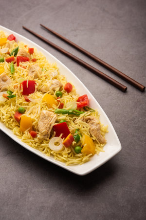 Chicken Fried rice is a popular Indian chinese or indo-chinese street food served in a plate with chopsticksの写真素材