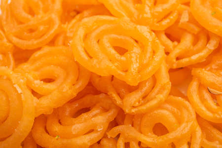 Crispy Sweet Jalebi, Jilapi, zulbia, mushabak or zalabia in white oval plate. selective focusの写真素材