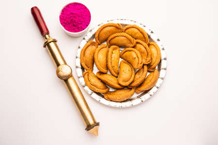 Gujiya or gujia or karanji - sweet dumplings made during the festival of holi and diwali, served in a plate. selective focusの写真素材