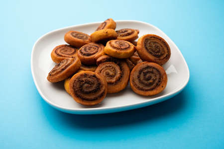 Indian Traditional tasty Snack Bhakarwadi Also Known as Bakarwadi, Bakarvadi, BhakarVadi or Bakar Wadi. Served in a plate or bowl. selective focusの写真素材