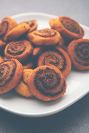 Indian Traditional tasty Snack Bhakarwadi Also Known as Bakarwadi, Bakarvadi, BhakarVadi or Bakar Wadi. Served in a plate or bowl. selective focusの写真素材