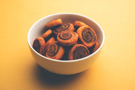 Indian Traditional tasty Snack Bhakarwadi Also Known as Bakarwadi, Bakarvadi, BhakarVadi or Bakar Wadi. Served in a plate or bowl. selective focusの写真素材
