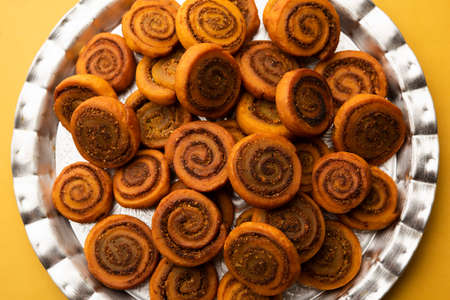 Indian Traditional tasty Snack Bhakarwadi Also Known as Bakarwadi, Bakarvadi, BhakarVadi or Bakar Wadi. Served in a plate or bowl. selective focusの写真素材
