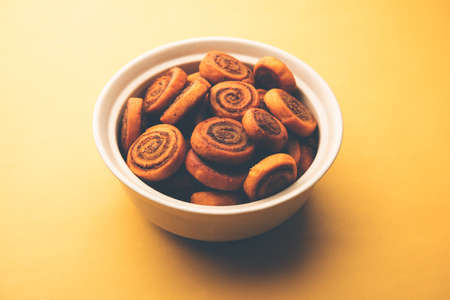 Indian Traditional tasty Snack Bhakarwadi Also Known as Bakarwadi, Bakarvadi, BhakarVadi or Bakar Wadi. Served in a plate or bowl. selective focusの写真素材