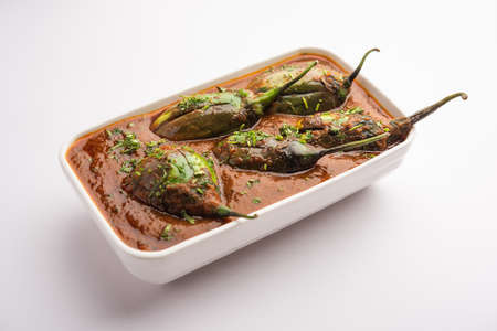 Brinjal curry also known as spicy baingan or eggplant masala, a popular main course recipe from India served in a bowl, karahi or panの写真素材