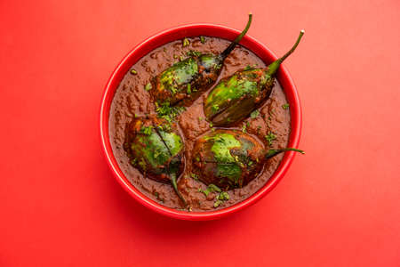 Brinjal curry also known as spicy baingan or eggplant masala, a popular main course recipe from India served in a bowl, karahi or panの写真素材