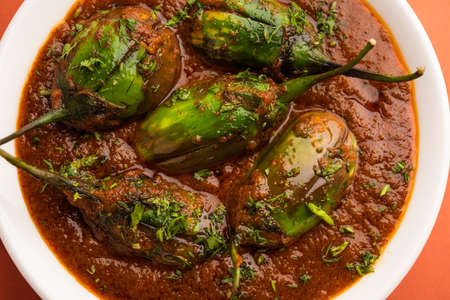 Brinjal curry also known as spicy baingan or eggplant masala, a popular main course recipe from India served in a bowl, karahi or panの写真素材