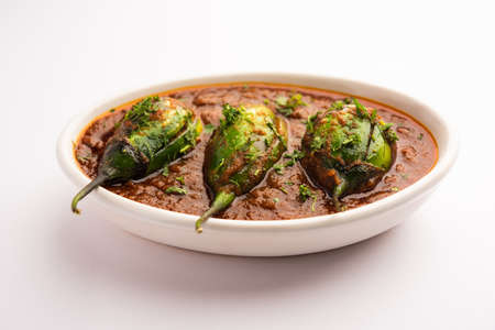 Brinjal curry also known as spicy baingan or eggplant masala, a popular main course recipe from India served in a bowl, karahi or panの写真素材