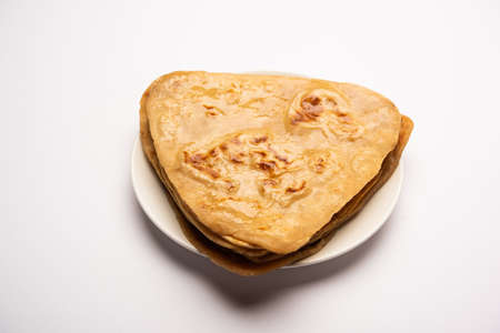 Triangle shape PlainÂ ParathaÂ or Parantha is yummyÂ Indian flat-bread made of whole-wheat flour. served in a plate, selective focusの写真素材