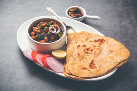 Tikona Paratha or Triangle parotha with chole or choley or chana masalaの写真素材