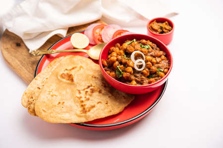 Tikona Paratha or Triangle parotha with chole or choley or chana masala