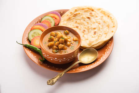 Chole or Chana Masala with Paratha, Chickpea spicy curry served with laccha parantha. Popular North Indian Dishの写真素材