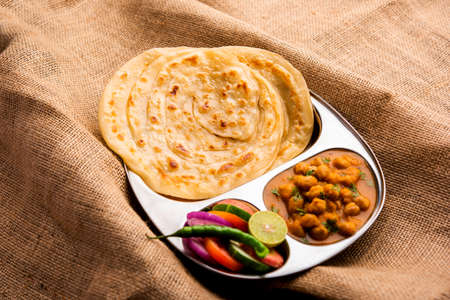 Chole or Chana Masala with Paratha, Chickpea spicy curry served with laccha parantha. Popular North...