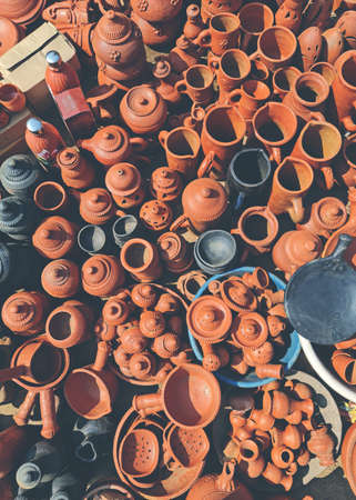Indian traditional terracotta or red clay pottery or earthenware kept on display in roadside shop in villageの写真素材