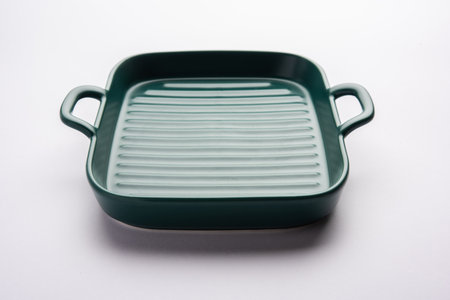 Empty green ceramic serving bowl or bakeware, isolated over white or gray background