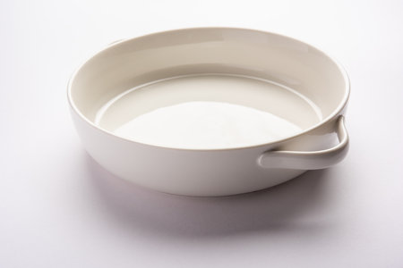 Empty white ceramic serving bowl, isolated over white or gray backgroundの写真素材