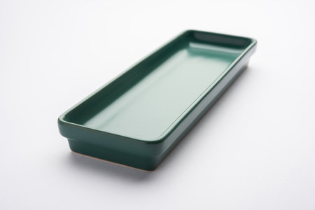 Empty green ceramic rectangular plate isolated on white backgroundの写真素材