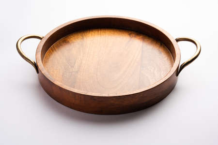 Empty wooden round tray with brass handle on white backgroundの写真素材