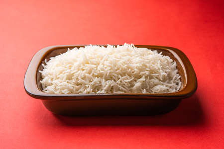 Aromatic Long Basmati cooked plain Rice is an Indian main course food, served in a bowl. selective focusの写真素材