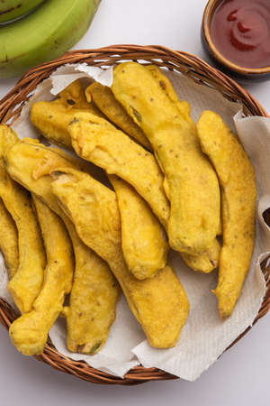 Banana Fritter or pakora or raw kela pakodaÂ or bajji served with chutney. Popular snack from Kerala, India or Indonesia. served with teaの写真素材