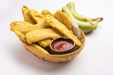 Banana Fritter or pakora or raw kela pakodaÂ or bajji served with chutney. Popular snack from Kerala, India or Indonesia. served with teaの写真素材