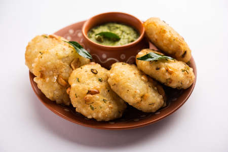 sabudana wada orÂ vada also known as Sago Fritters in india served with coconut chutney, Fasting...