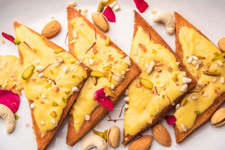 Shahi tukda or tukra also known as double ka meetha is a rich & festive Indian dessert made with bread, ghee, sugar, milk and nutsの写真素材
