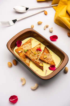 Shahi tukda or tukra also known as double ka meetha is a rich & festive Indian dessert made with bread, ghee, sugar, milk and nutsの写真素材
