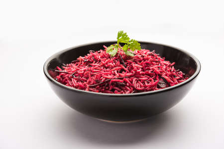 Beetroot Rice or pulao or pulav served in a bowl or karahi, selective focus. Indian food