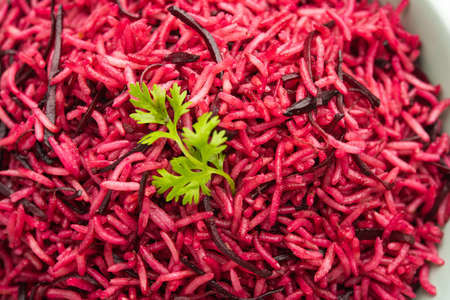 Beetroot Rice or pulao or pulav served in a bowl or karahi, selective focus. Indian food