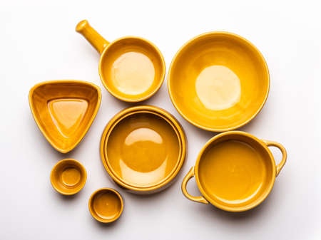Collection of empty colorful ceramic bowls. Group of utensils captured from above, top view, flat lay against white backgroundの写真素材