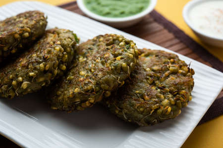 Sprouted moong dal tikki or patties is a healthy snack from India served with green chutney and curdの写真素材