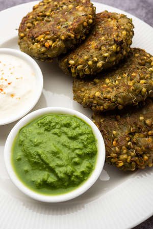 Sprouted moong dal tikki or patties is a healthy snack from India served with green chutney and curdの写真素材