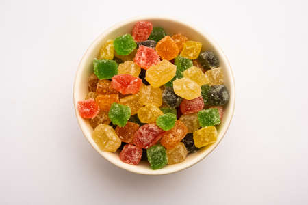 Indian colorful candy and jelly bites sweet, fruit flavoured confectionery coated with sugar, served in a plate or bowlの写真素材