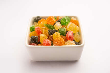 Indian colorful candy and jelly bites sweet, fruit flavoured confectionery coated with sugar, served in a plate or bowlの写真素材