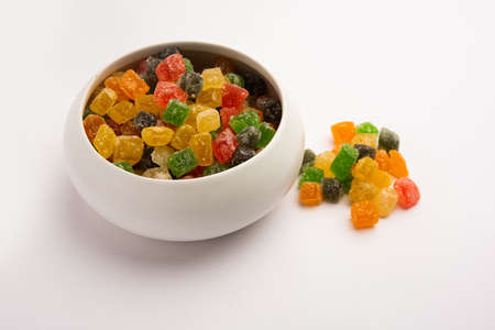 Indian colorful candy and jelly bites sweet, fruit flavoured confectionery coated with sugar, served in a plate or bowlの写真素材