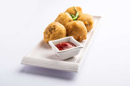 aalu bonda is an indian pakora or batata vada served with ketchupの写真素材