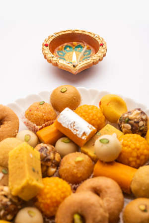 Group of Indian assorted sweets or mithai with diyaの写真素材