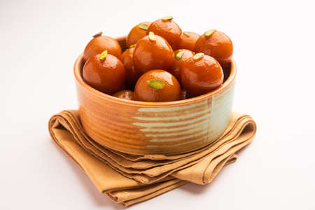 Indian sweet food Gulab Jamun served in a round ceramic bowl