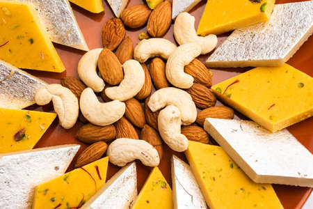 Kaju and badam Katli is a popular indian sweet barfee, barfi or burfi made using milk, khoya, cachew and almond and Sugarの写真素材