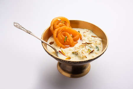 Rabri jalebi or imarati with rabdi made from condensing milk, famous dessert sweet from Indiaの写真素材