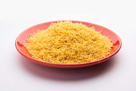 Besan Sev or Indian Namkeen Noodles of chickpea flour. Popular GujaratiÂ Deep fried Teatime Snack.