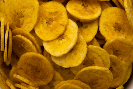 Healthy Homemade Kela or Banana chips or wafers served over moody background, selective focusの写真素材
