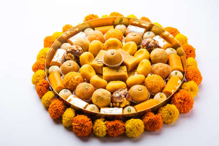 Group of Indian assorted sweets or mithai with diya