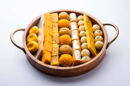 Group of Indian assorted sweets or mithai with diya