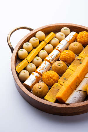 Group of Indian assorted sweets or mithai with diya
