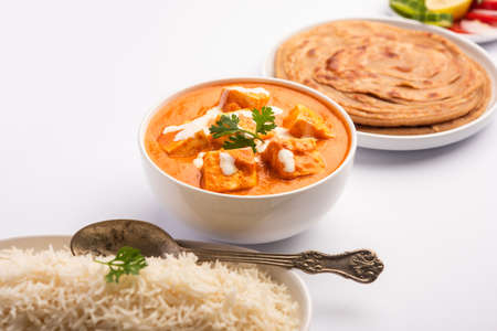 Paneer Butter Masala or Cheese Cottage Curry served with rice and laccha parathaの写真素材