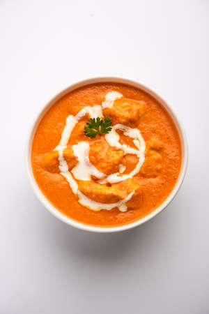 Tasty butter chicken curry dish from Indian cuisine served with rice and parathaの写真素材