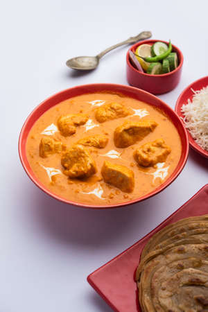 Tasty butter chicken curry dish from Indian cuisine served with rice and parathaの写真素材