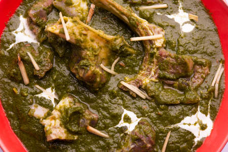 Palak Gosht or mutton curry, Indian style spinach and lamb curry served with rice and laccha paratha